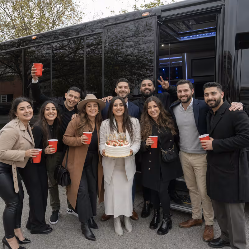 Group boarding a white charter bus for Birthday Transportation transportation in Dallas