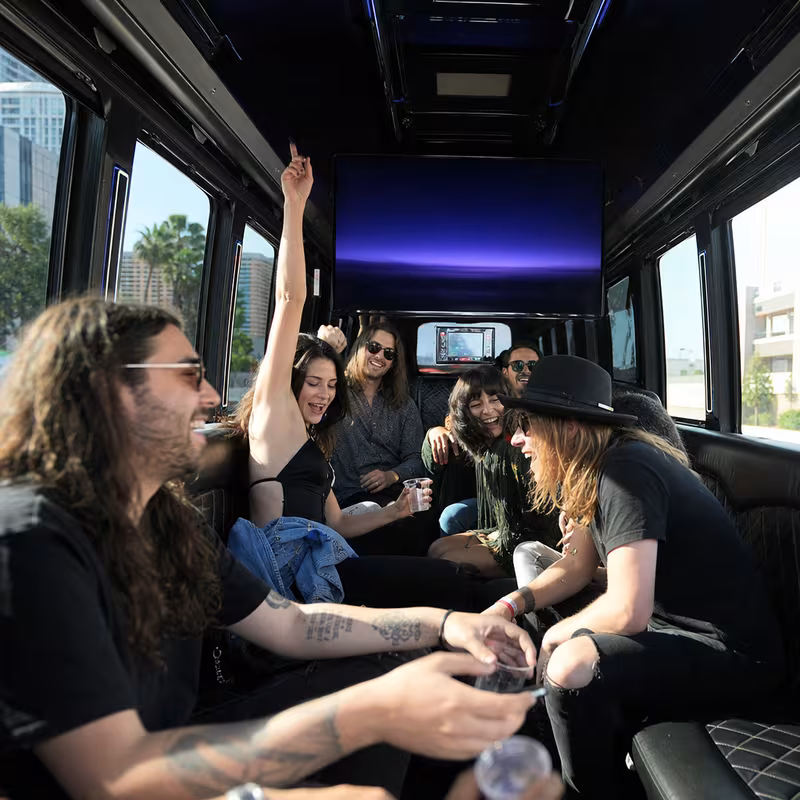 Group boarding a white charter bus for Concert Transportation transportation in Dallas