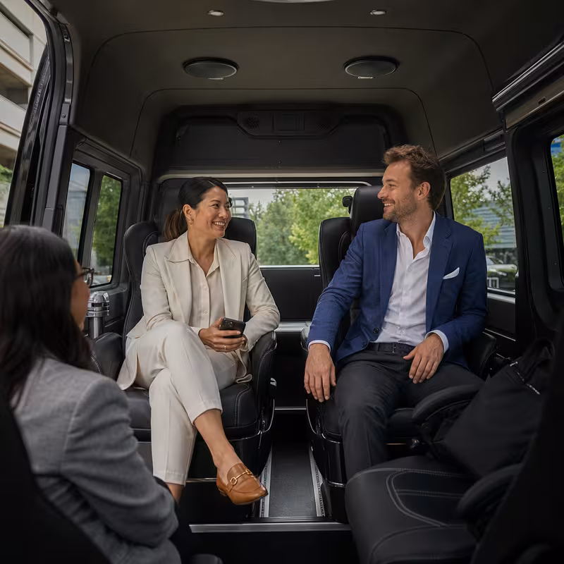 Group boarding a white charter bus for Corporate Transportation transportation in Dallas
