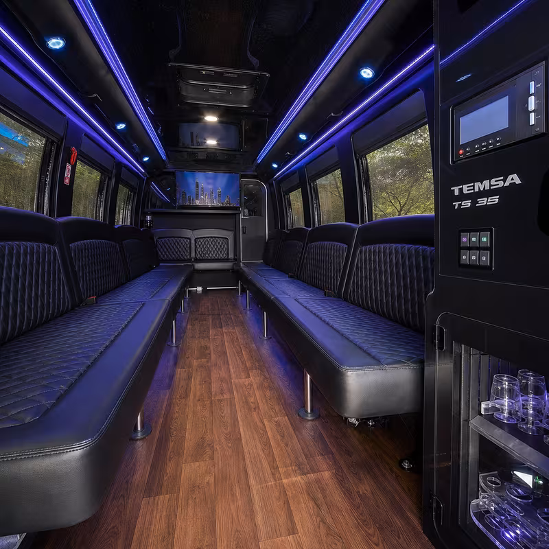 Party bus interior with wraparound leather seating and LED lighting in Dallas