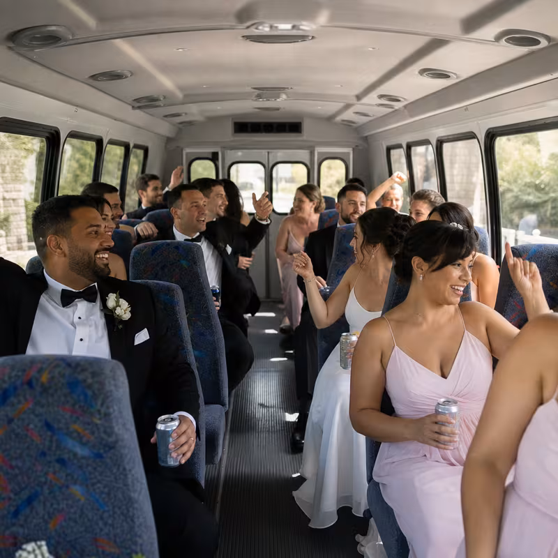 Group boarding a white charter bus for Wedding Transportation transportation in Dallas