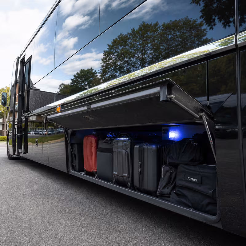 Party bus interior with wraparound leather seating and LED lighting in Dallas