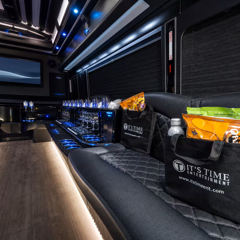 Party bus interior with wraparound leather seating and LED lighting in Dallas
